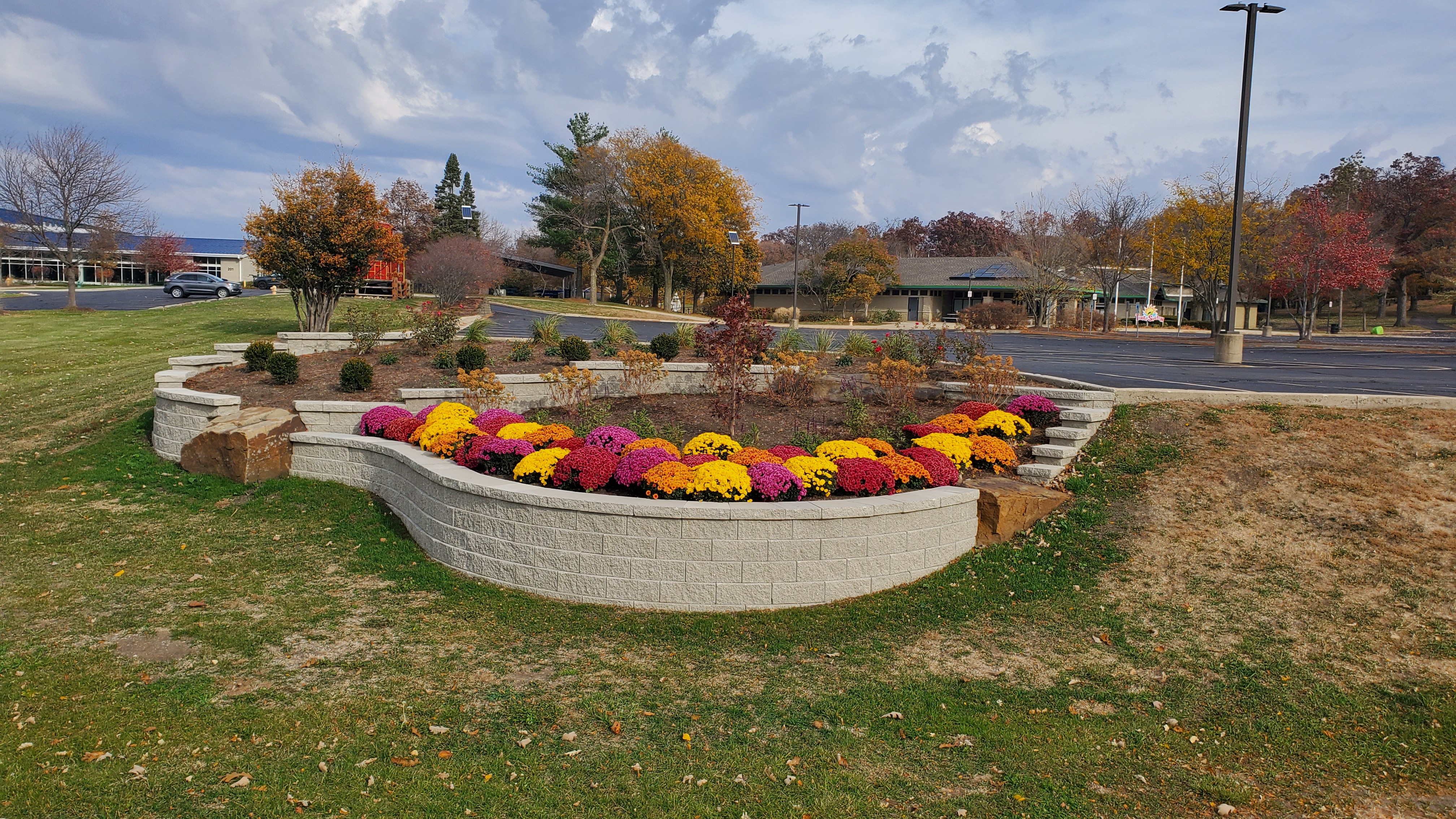 Multi-level retaining wall with integrated boulders and fall plants, West Chicago, IL — B&L Landscape drainage