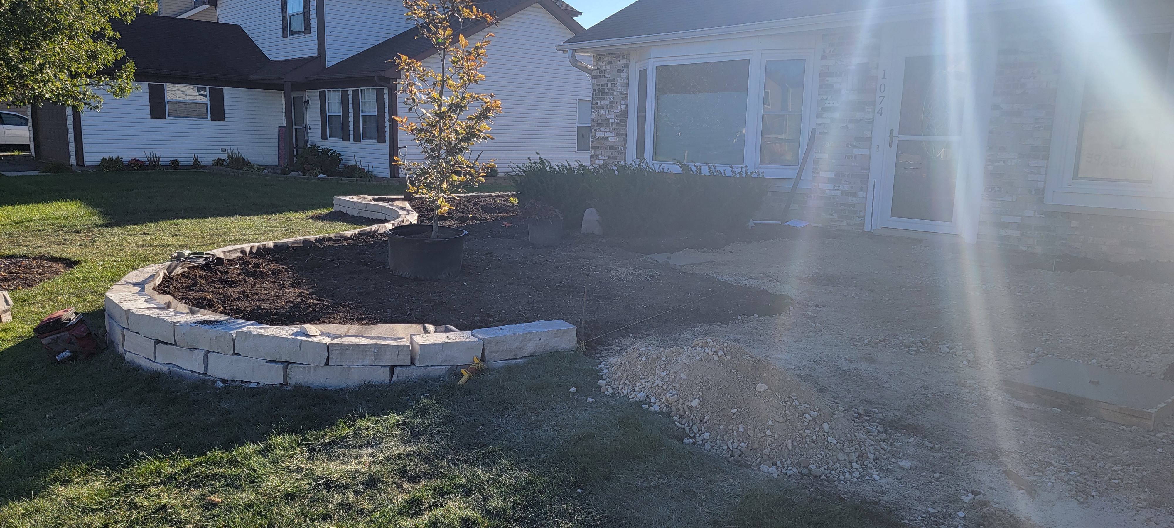 Natural stone retaining wall in progress installation, Carol Stream, IL — B&L Landscape drainage