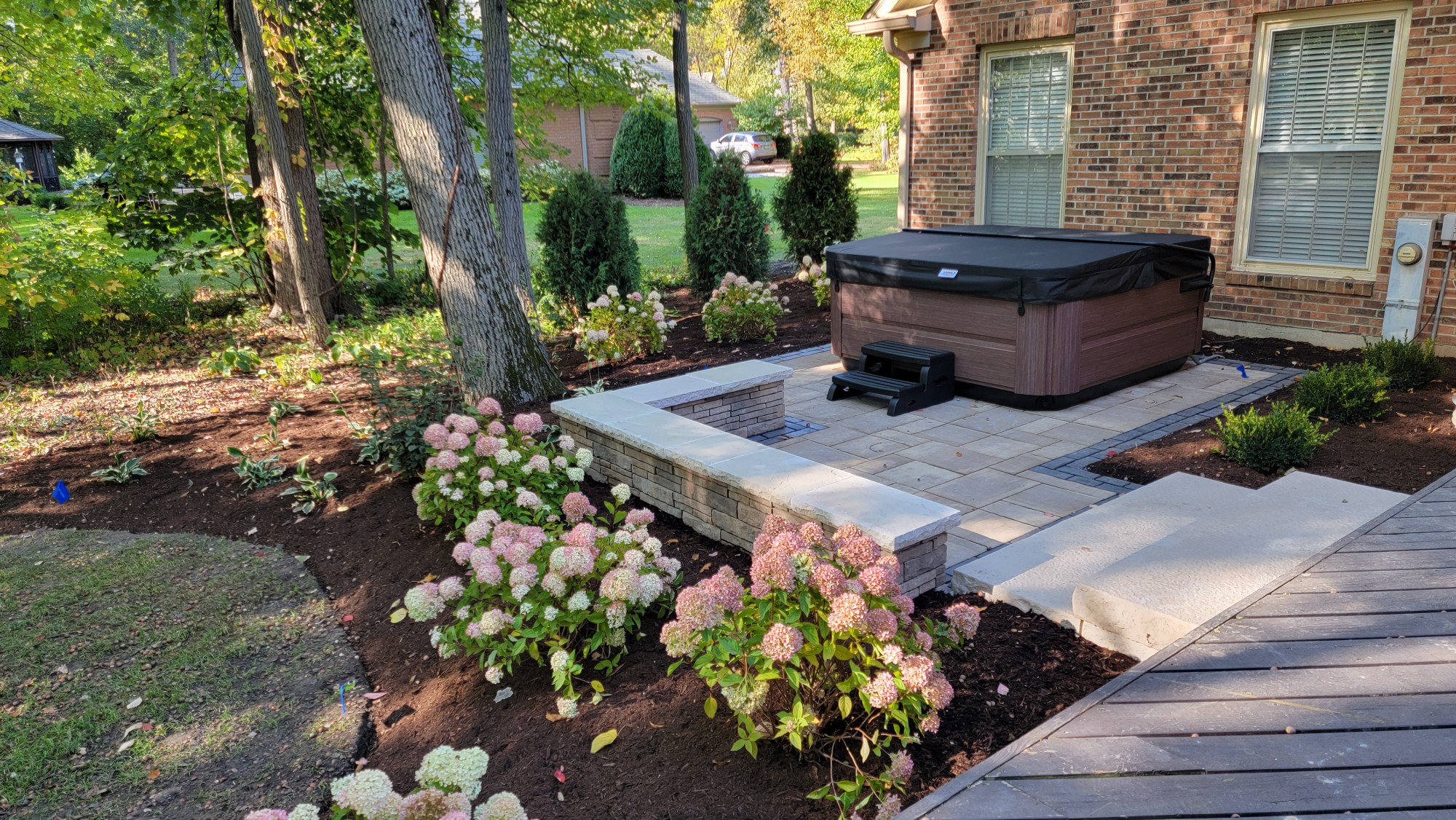 Back paver patio with seat wall and hot tub, St. Charles, IL — B&L Landscape