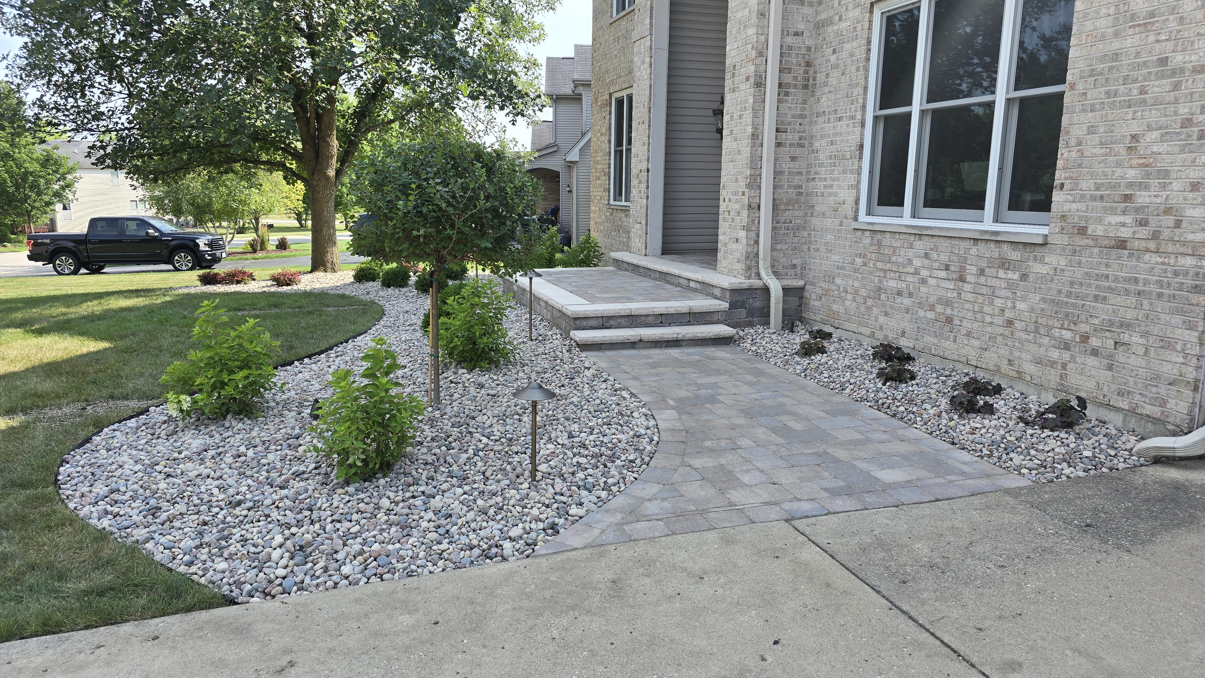 New front paver walkway and stoop with decorative stone, planting, and landscape lights, Bartlett, IL — B&L Landscape