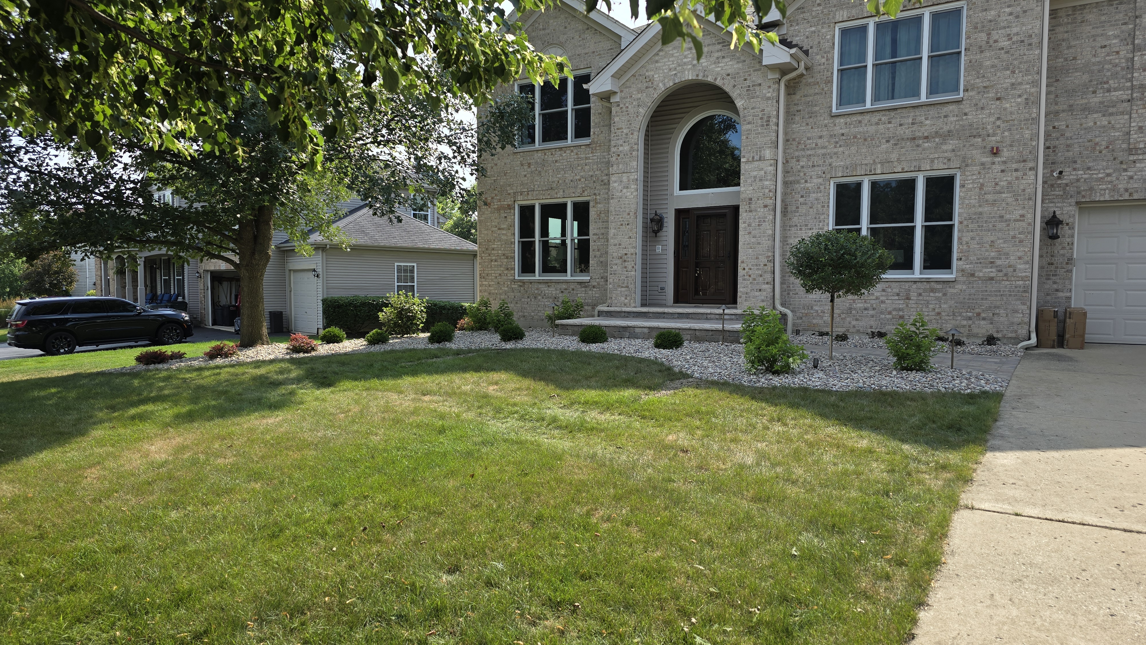 New front landscaping with front stoop and decorative stone, Bartlett, IL — B&L Landscape