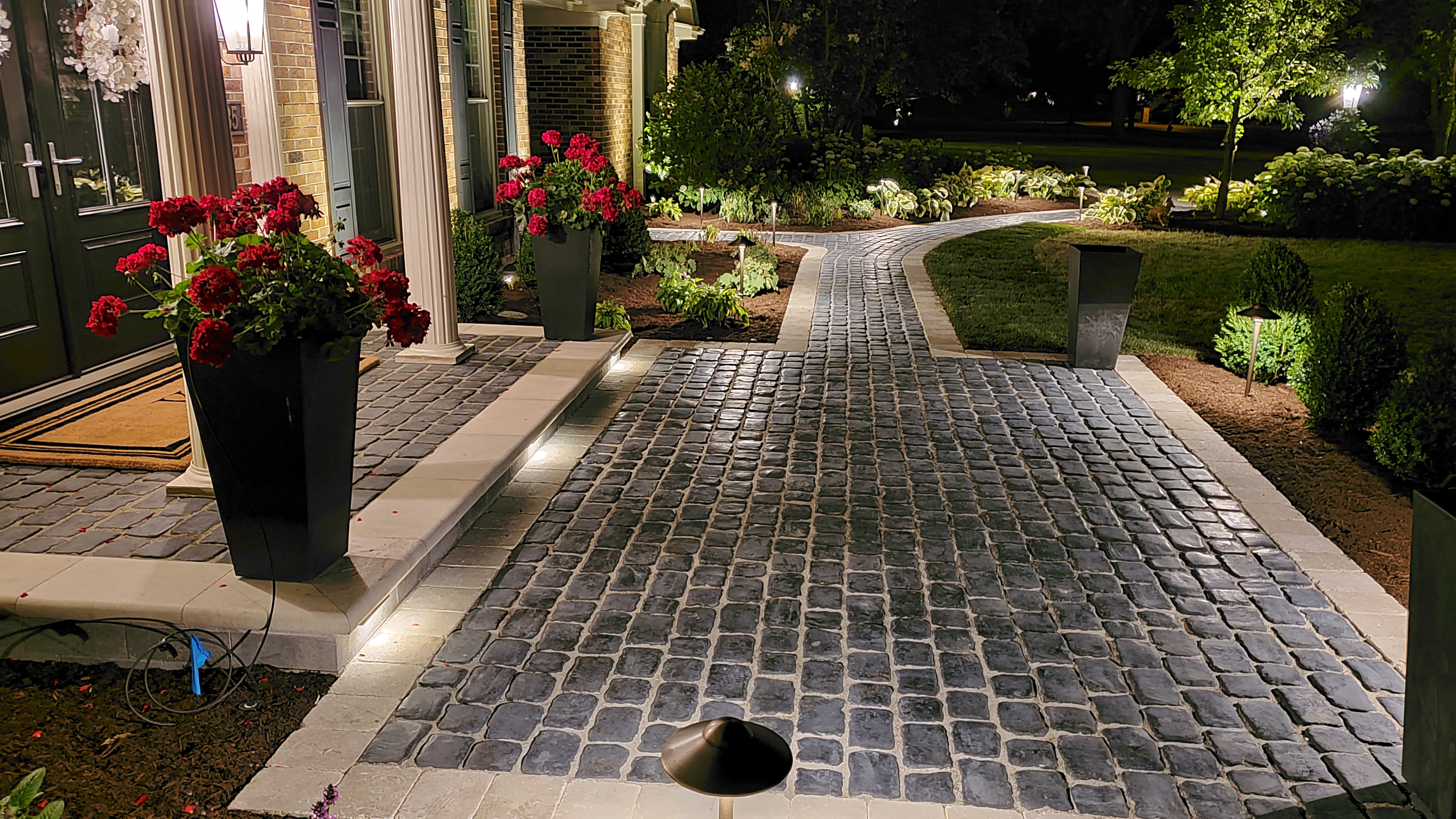 Front door walkway at night with landscape lights, St. Charles, IL — B&L Landscape