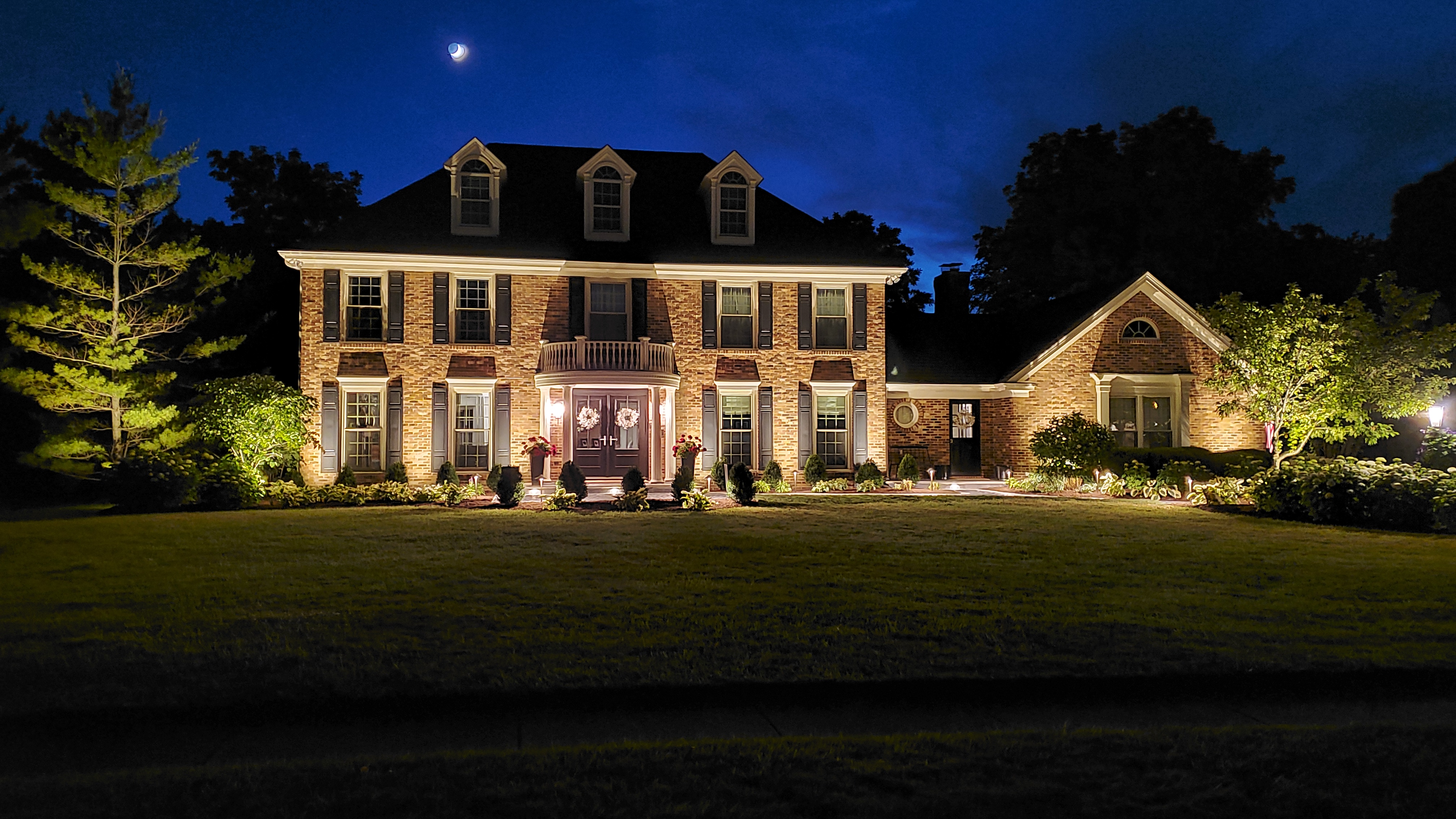 Front of house at night with landscape lights, St. Charles, IL — B&L Landscape