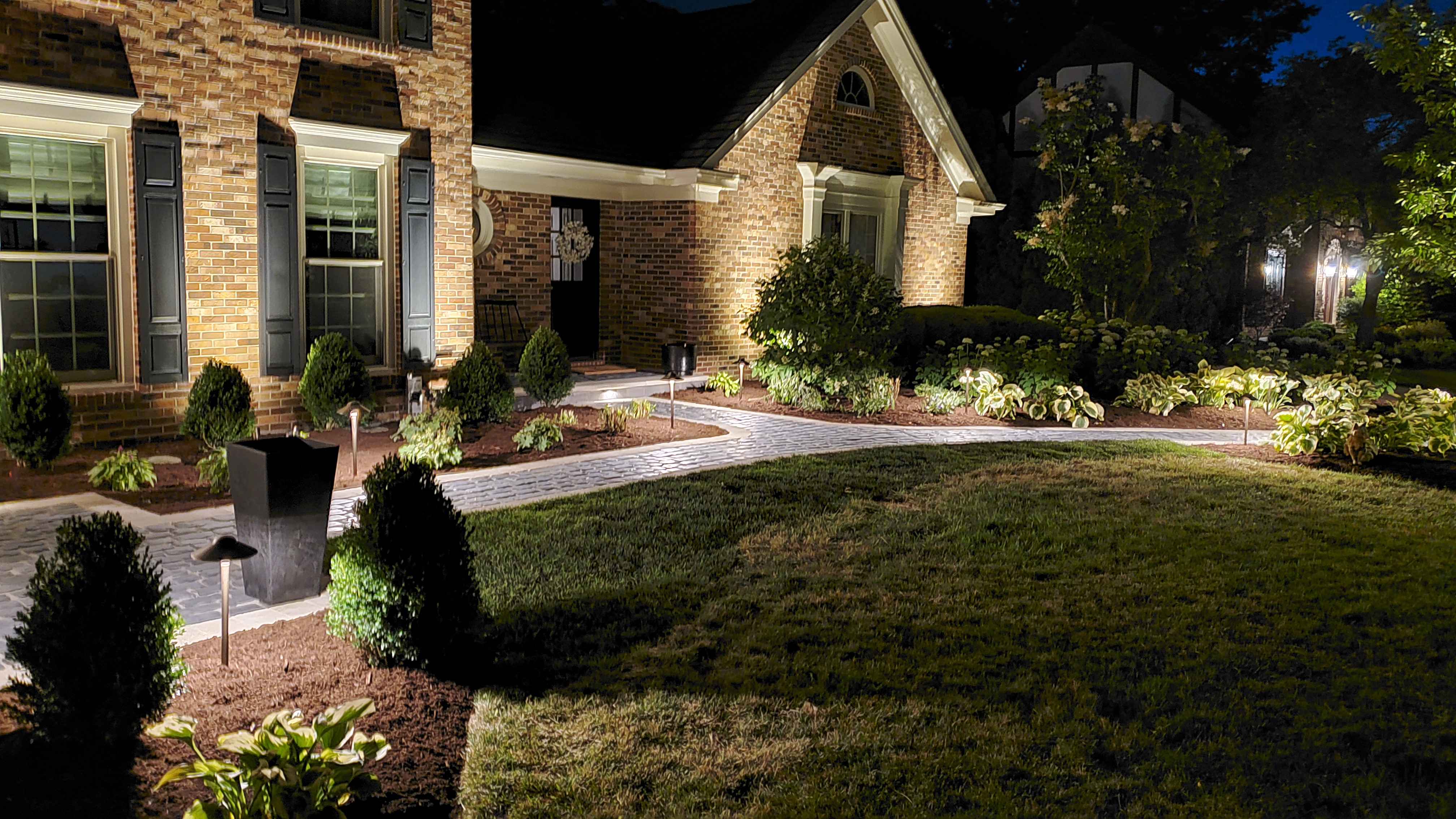 Front paver walkway at night with landscape lights, St. Charles, IL — B&L Landscape