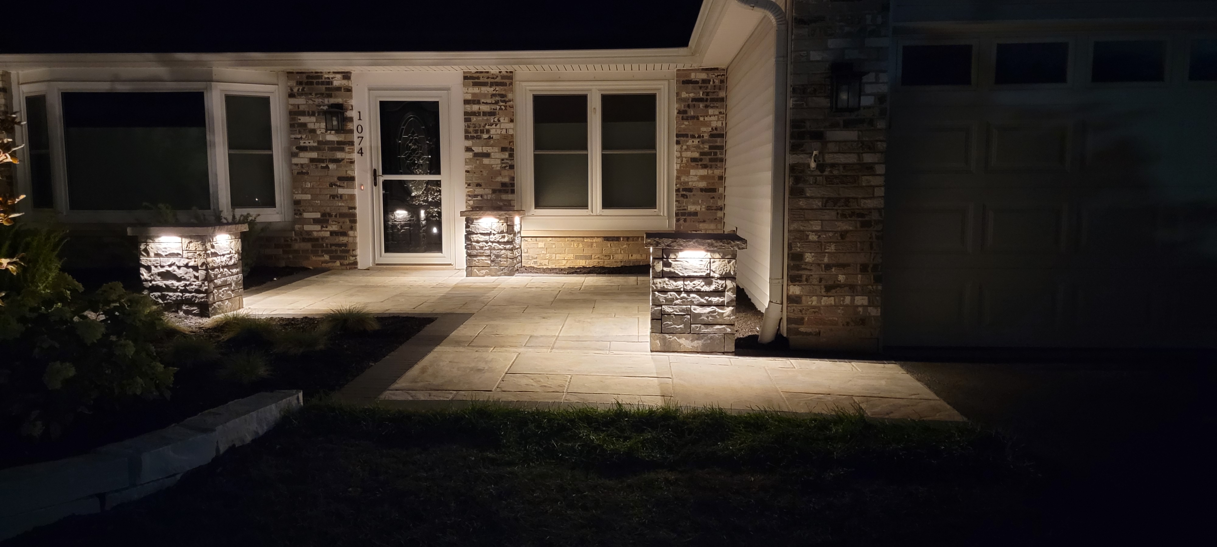 Front paver walkway with pillars at night with landscape lights, Carol Stream, IL — B&L Landscape